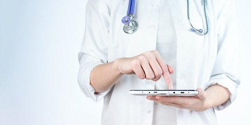 Close up of doctor inputting information on a tablet